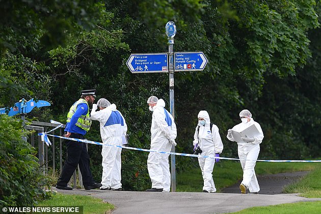 Police and forensic officers at the scene of the alleged murder last year